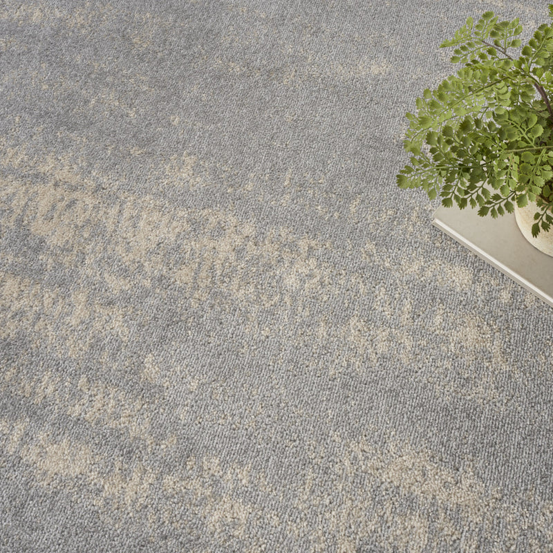 Gray and beige abstract square area rug surface with mottled texture.