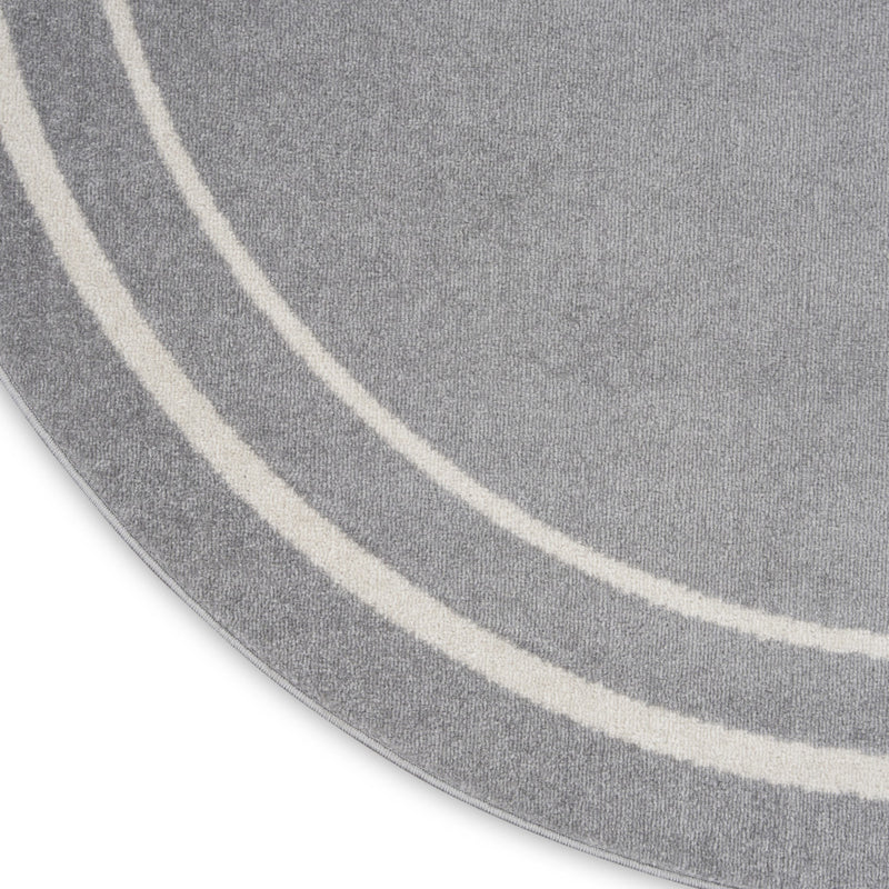 Gray round rug edge with ivory double stripe accents, visible woven texture