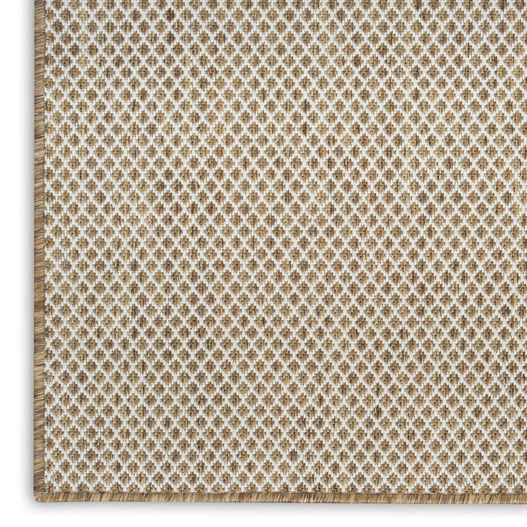 Geometric area rug in natural and ivory diamond lattice pattern with fringed edge detail