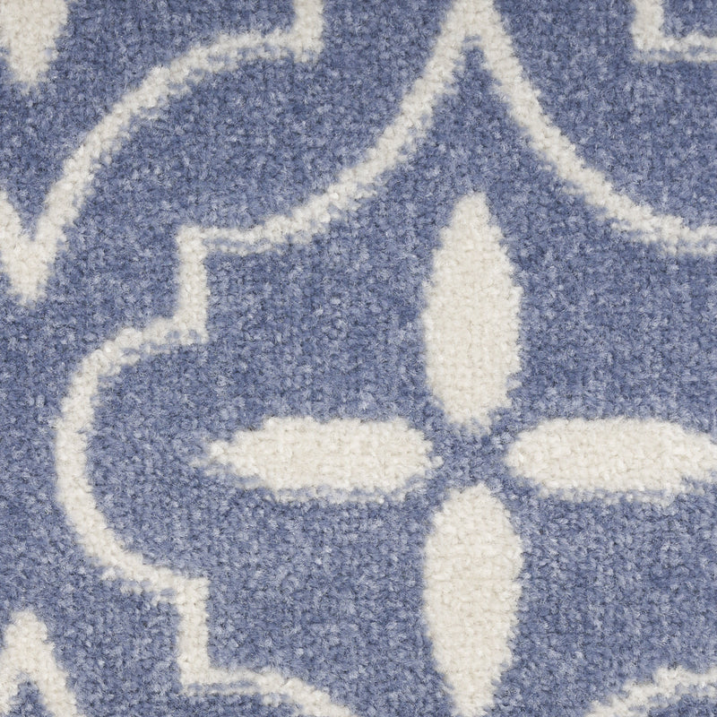 Blue and ivory geometric area rug close-up, textured quatrefoil lattice design