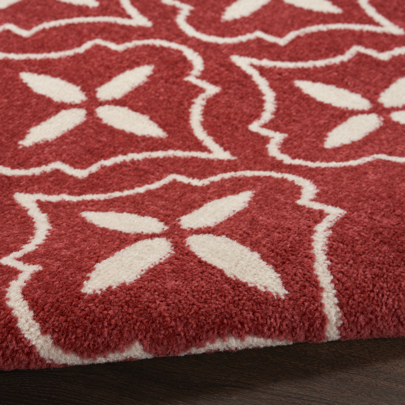 Brick red geometric area rug with scattered ivory star motifs and crisp outline borders.