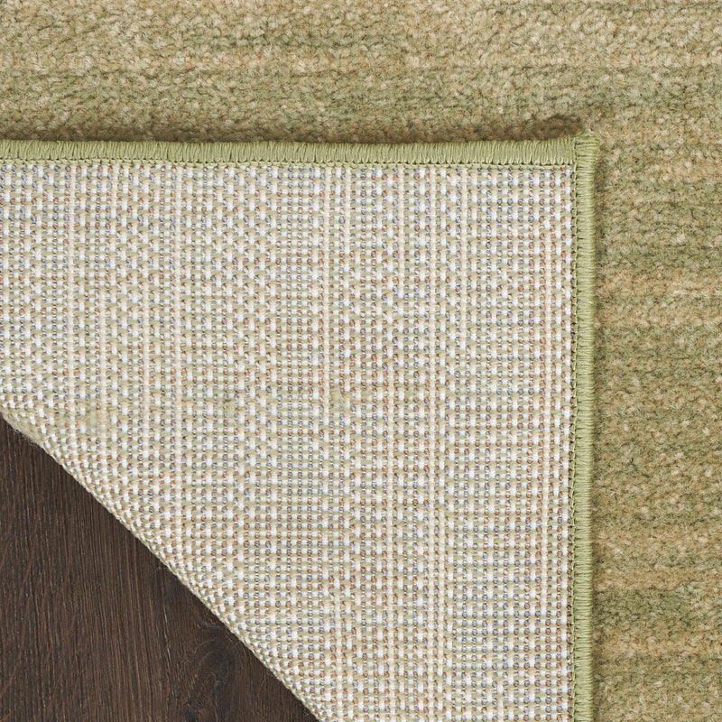 Area rug border corner showing flat woven backing and tight, textured interior pile