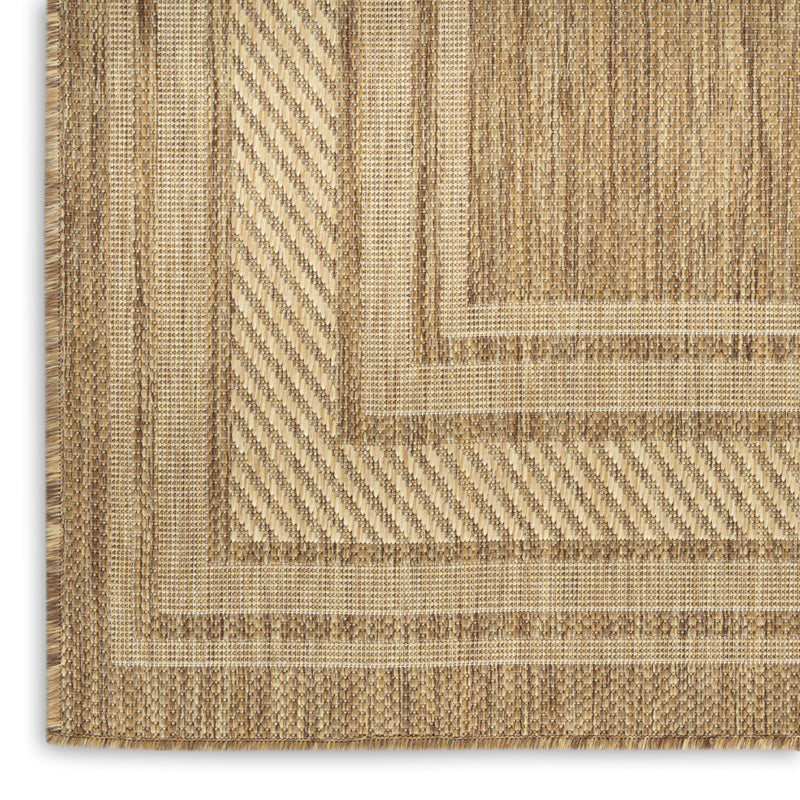 Natural geometric area rug with tan and beige chevron pattern and bound edge