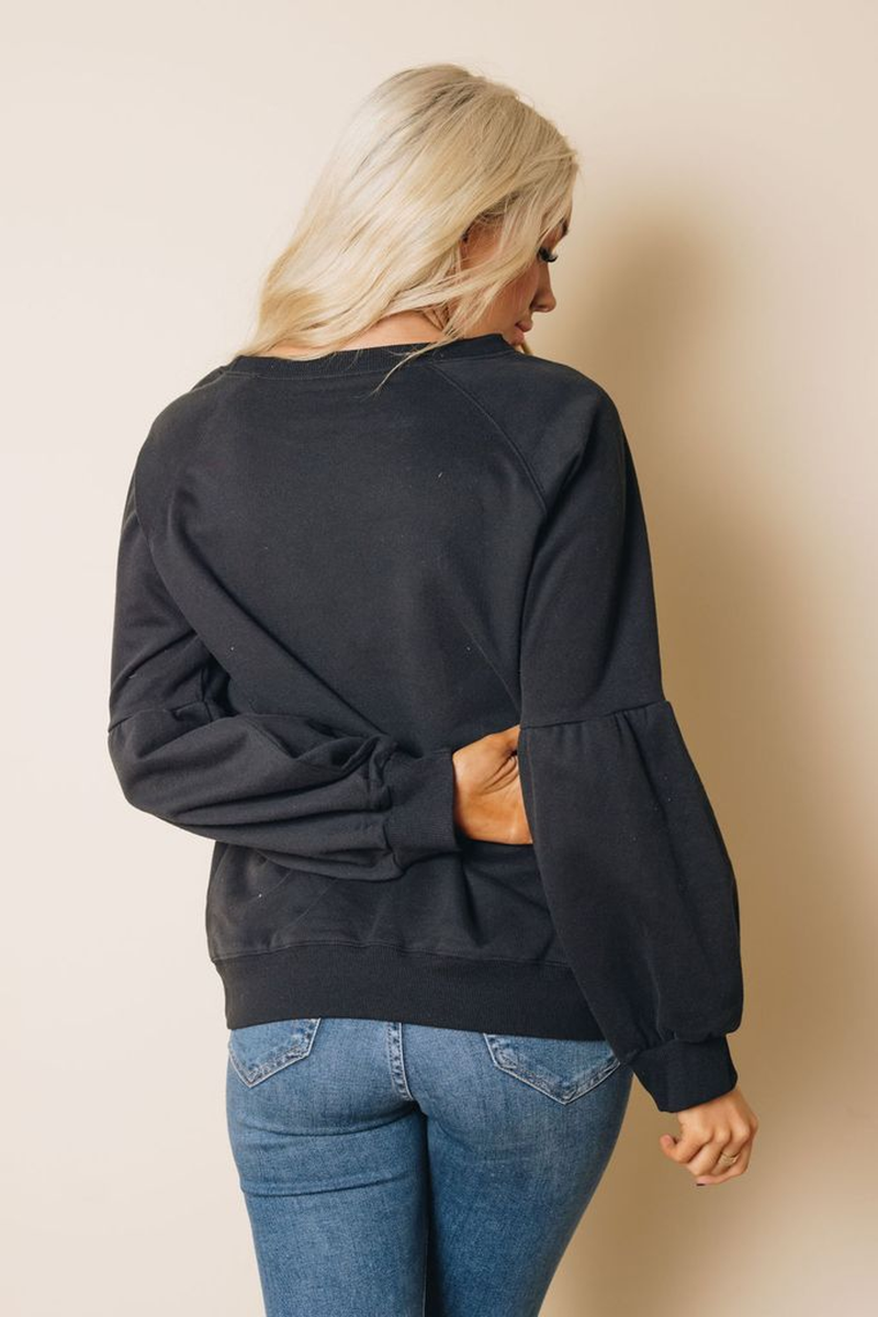 Dark charcoal balloon sleeve sweatshirt from the back, with crew neck and pocket.