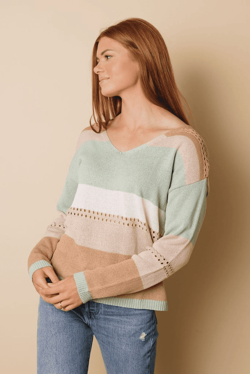 Color block knitted sweater front view with V-neck and ribbed sleeve cuffs
