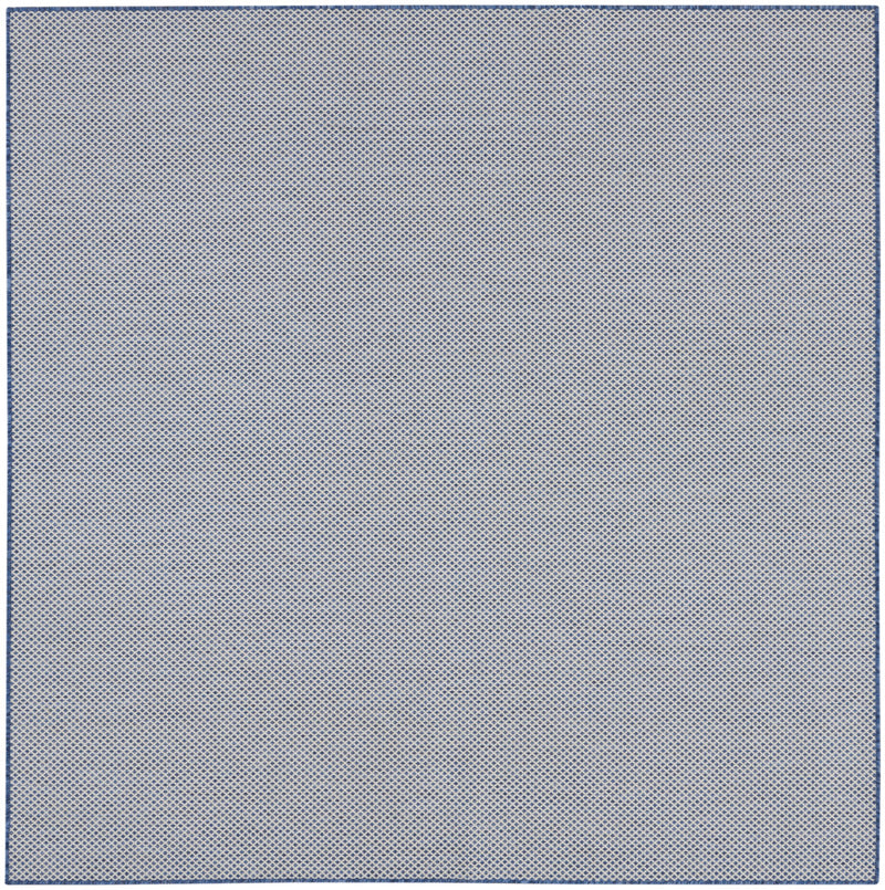Indoor/outdoor area rug with all-over blue and ivory dot-diamond texture