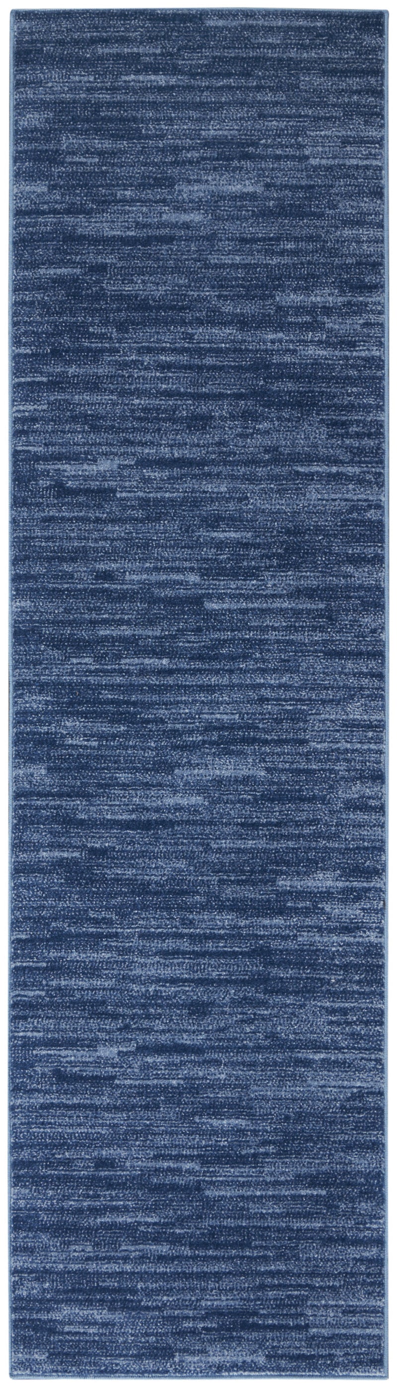 Blue long runner rug with dense short pile and subtle layered striping texture.