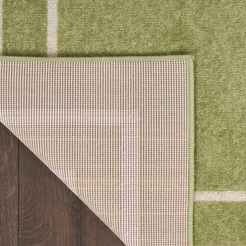 Rug edge with ivory border binding and grid-textured backing detail