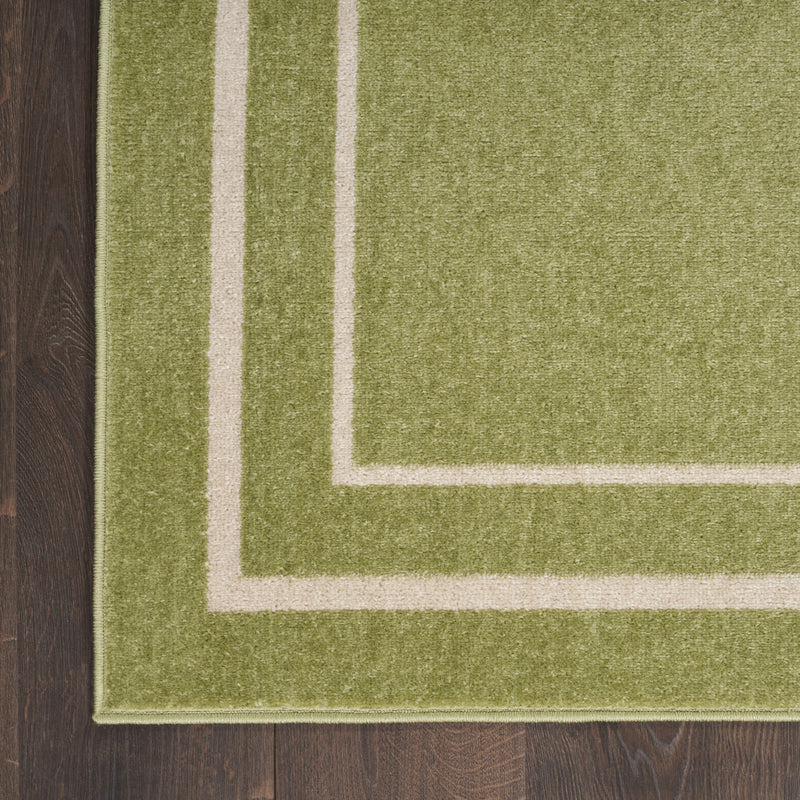 Green rug panel with ivory corner border stripes and low-pile woven texture