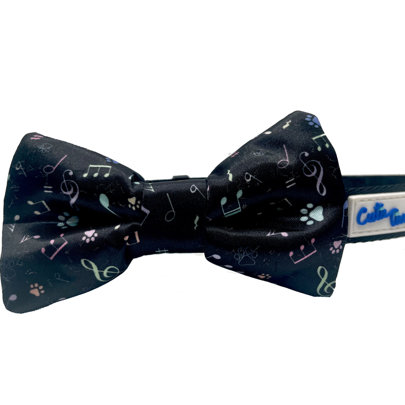 Dog bow tie with dark navy black fabric and music-note paw print pattern