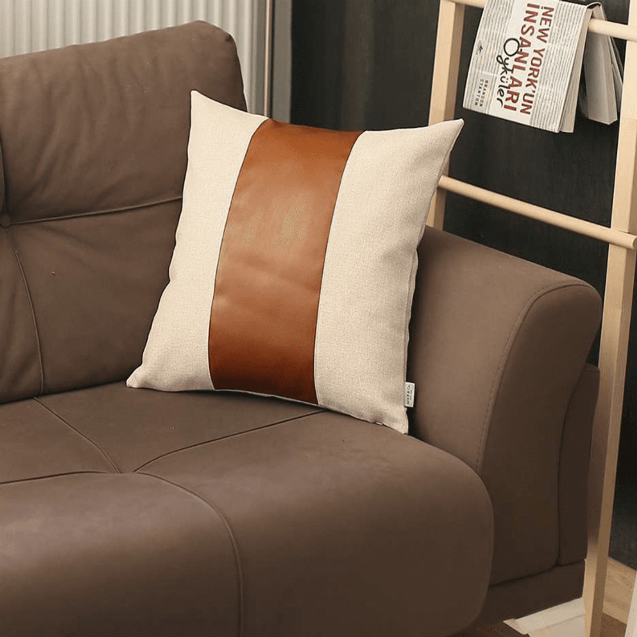 Two-tone decorative throw pillow cover with brown faux leather center stripe, cream border.