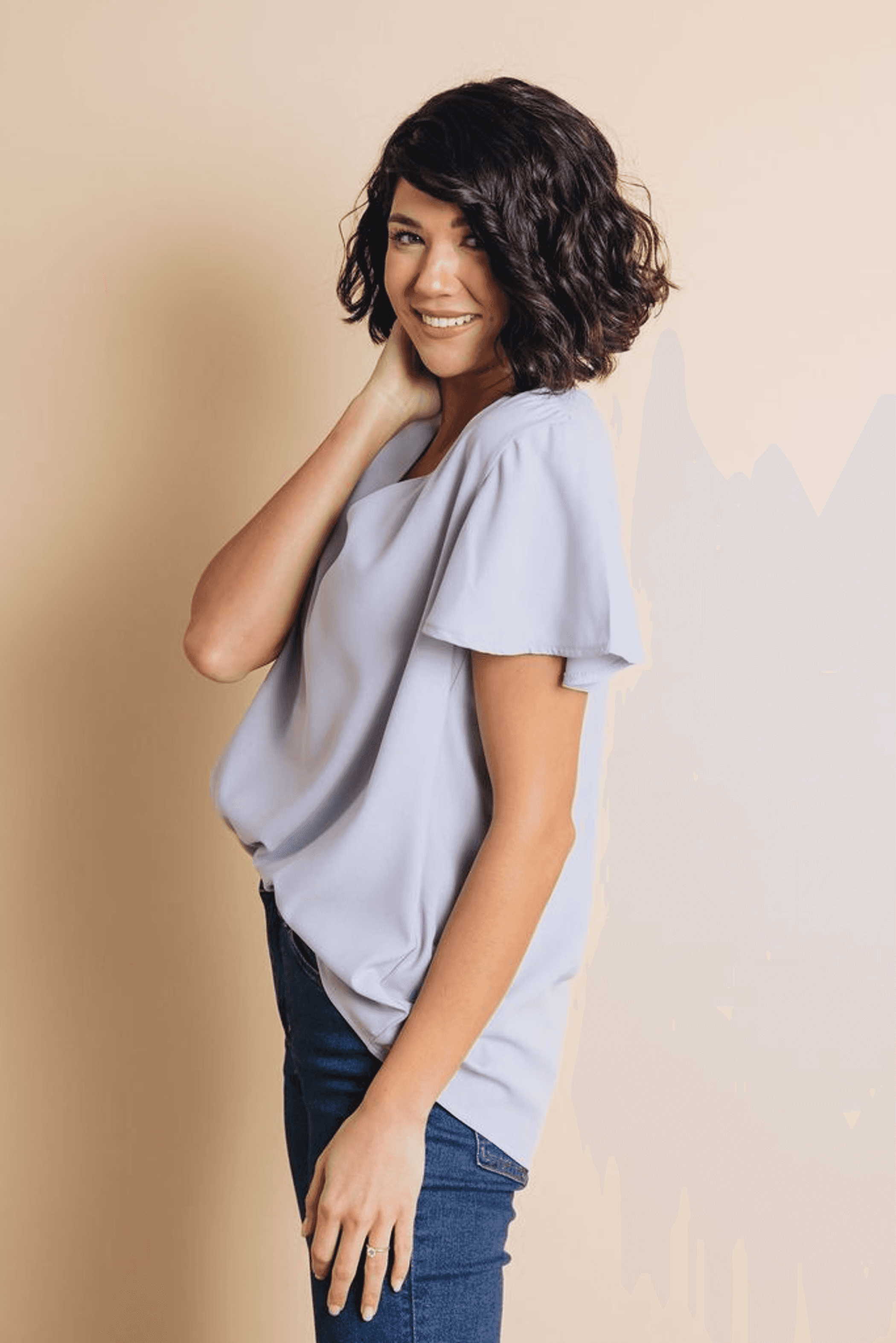 Light blue short-sleeve V-neck top with flared sleeves and soft drape