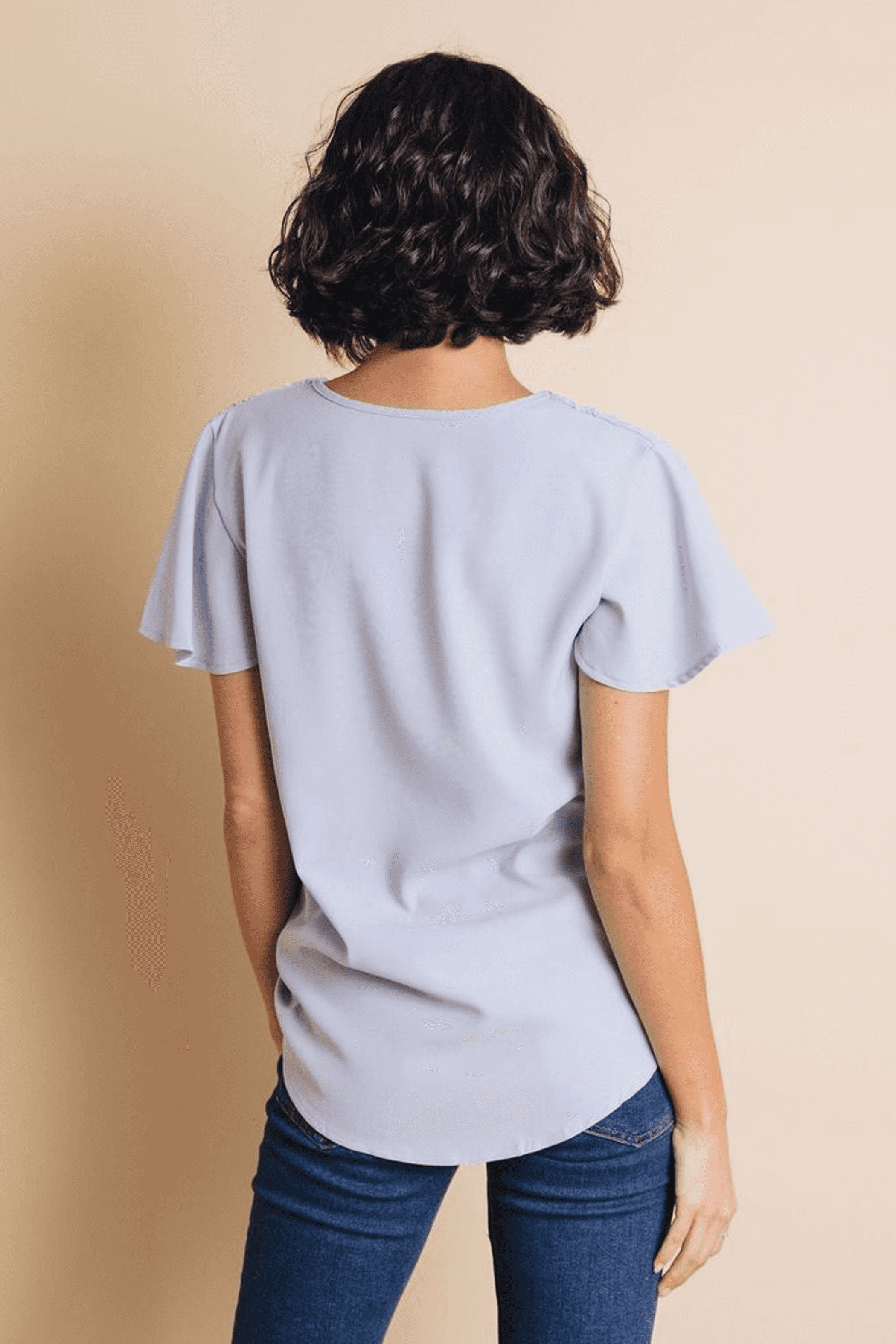 Light blue short-sleeve top with scooped back and relaxed, draped fit