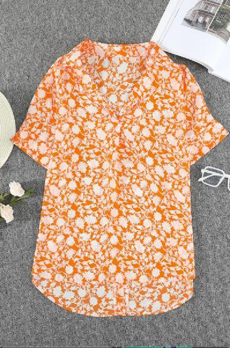 Orange floral print drape-front blouse with short sleeves and V-neck