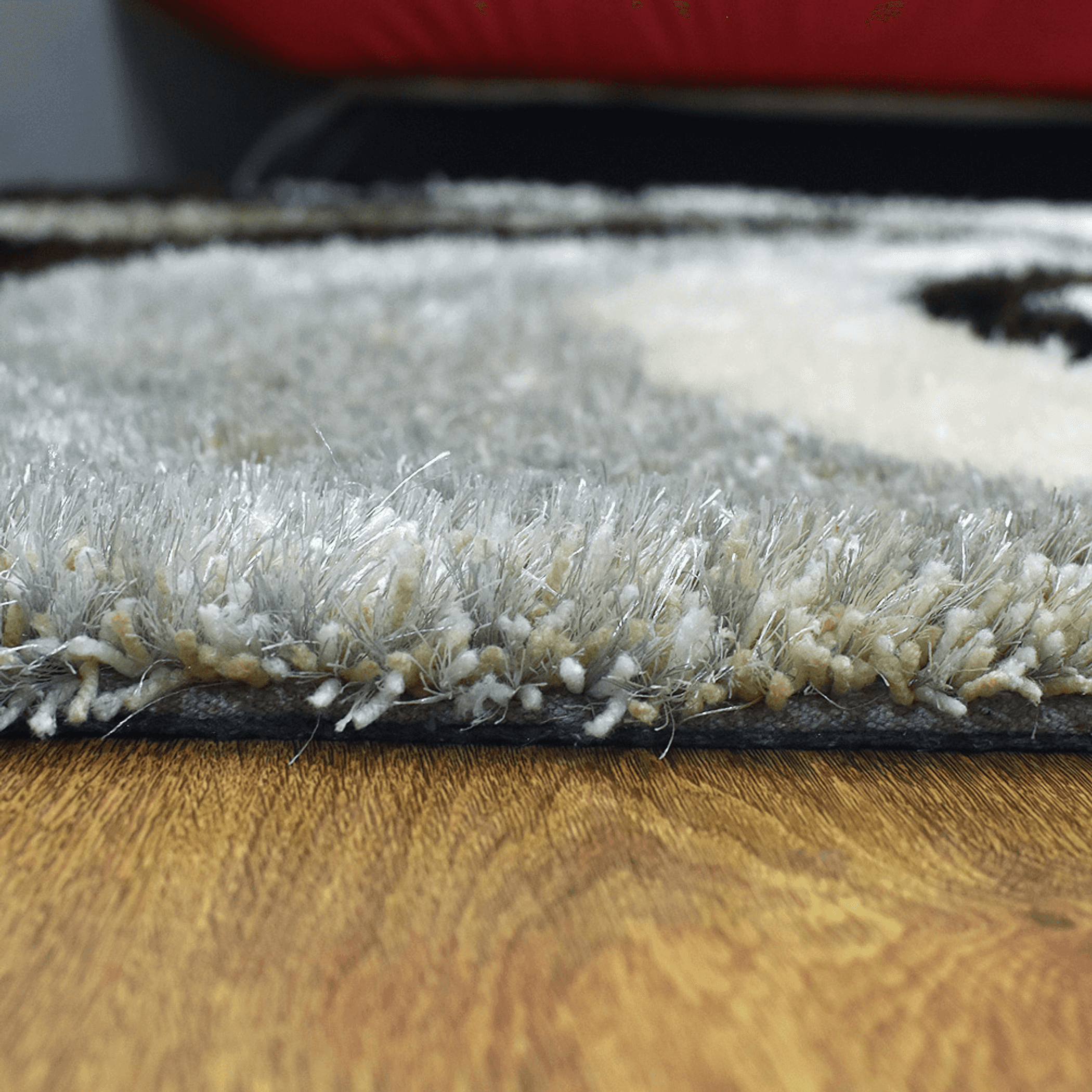 Gray shag area rug pile edge viewed from side