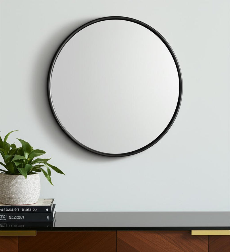 Round black metal framed accent mirror with reflective glass surface