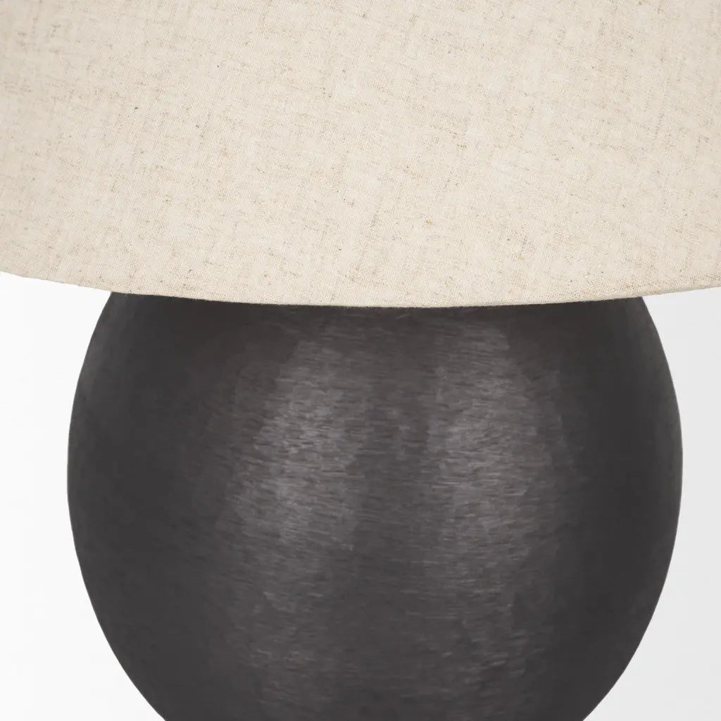 Black textured ceramic lamp with a beige linen shade, perfect for modern and minimalist decor.
