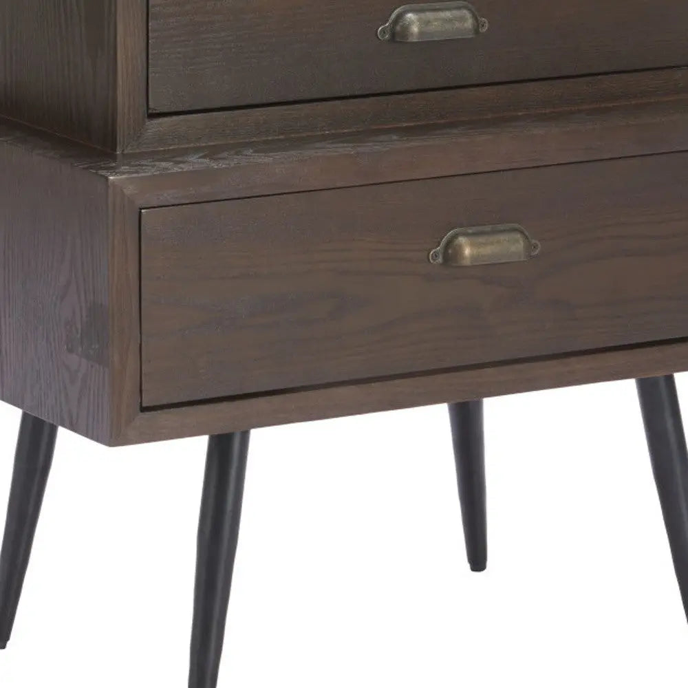 Mid-century modern dark wood nightstand with brass handles and tapered black legs, featuring two spacious drawers.