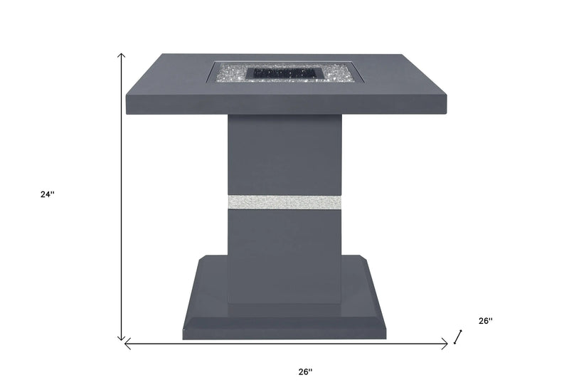 Modern gray square fire pit table with decorative glass stones, 24" height, and stylish metallic accent strip.