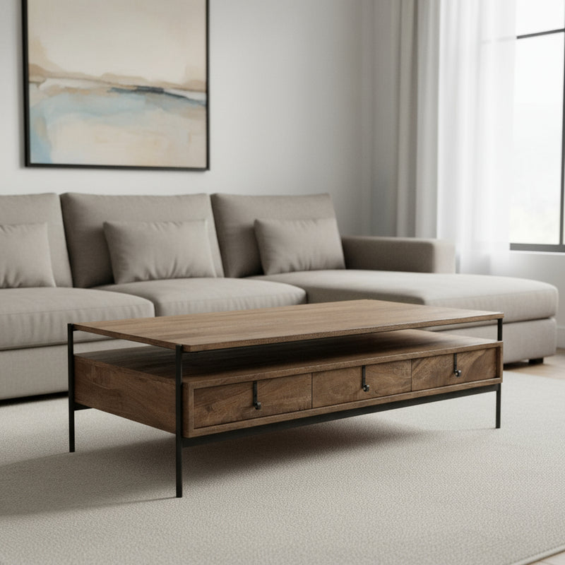 Brown wood coffee table with three drawers, black metal legs, styled in a living room