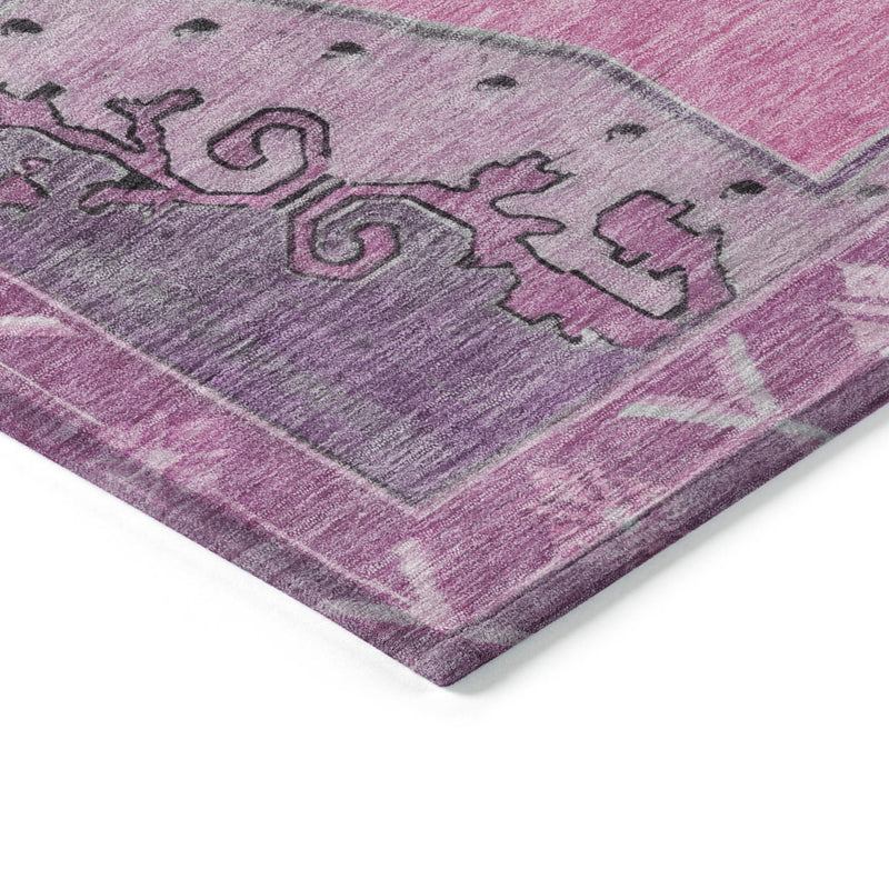 Angled close-up of pink geometric rug with gray scroll motifs and thick texture