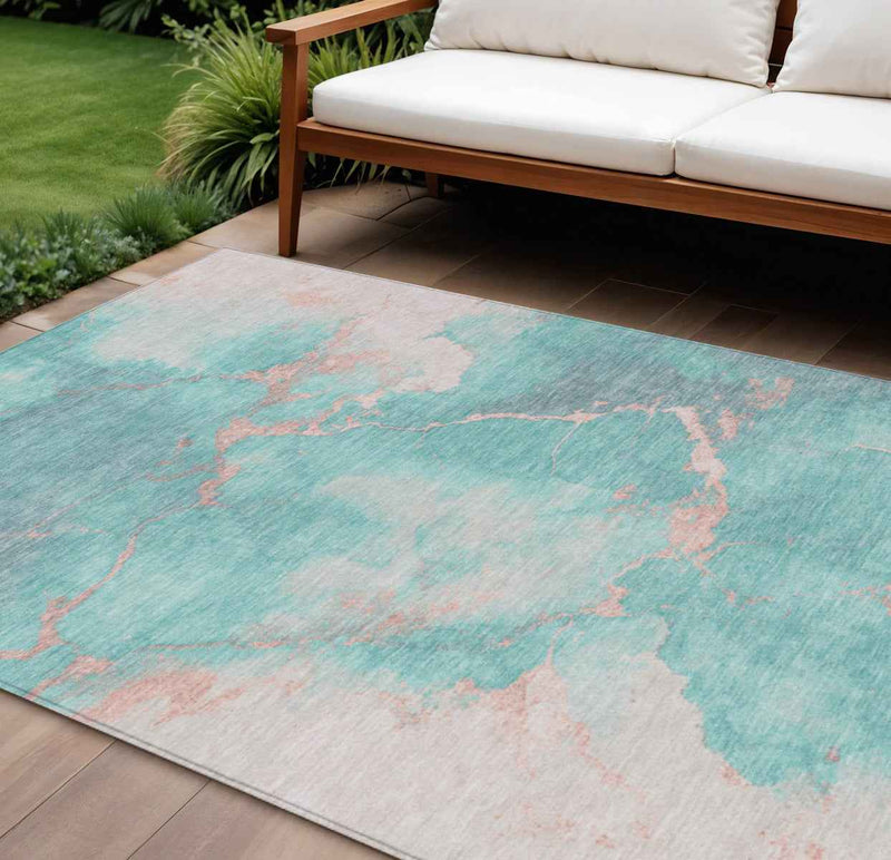 9' X 12' Teal Blue Peach And Ivory Abstract Washable Indoor Outdoor Area Rug
