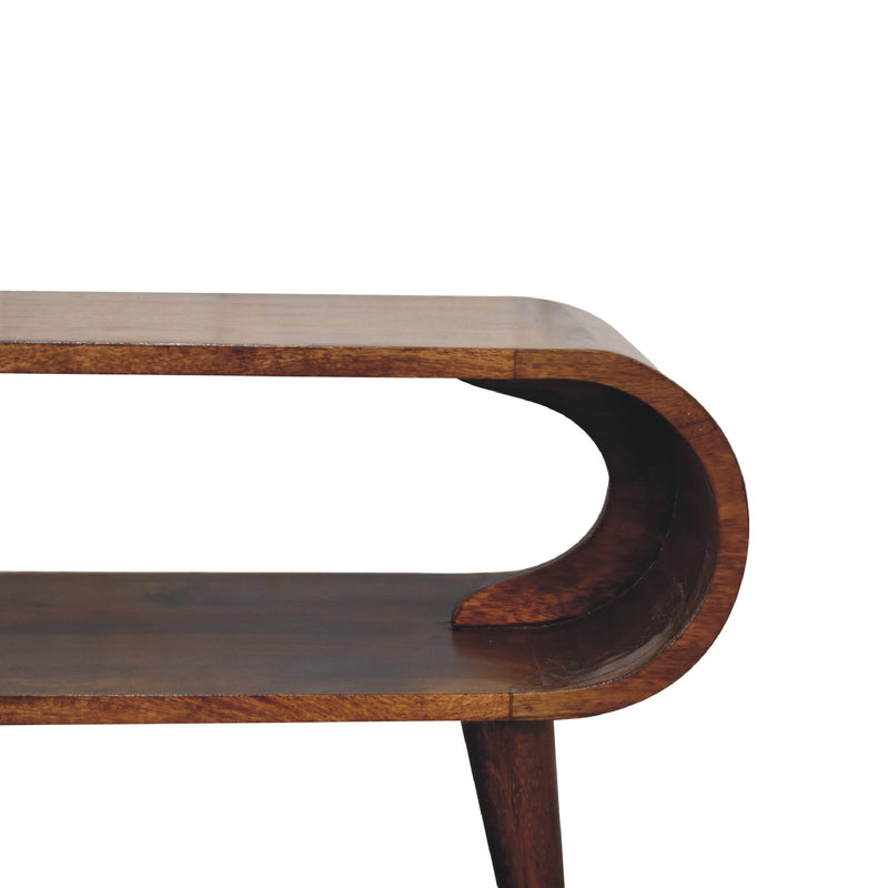 Chestnut wood coffee table corner detail with rounded apron cutout and tapered leg.