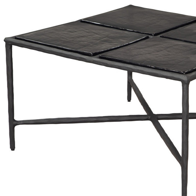 Black square glass coffee table with aluminum frame and four-panel glass top, angled view