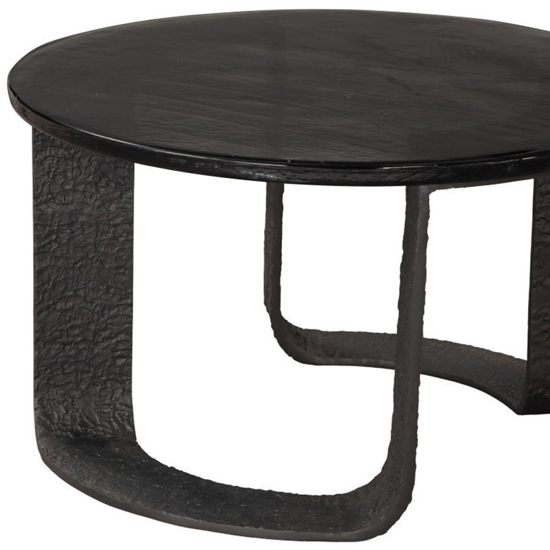Black round pedestal coffee table with textured base and side profile legs