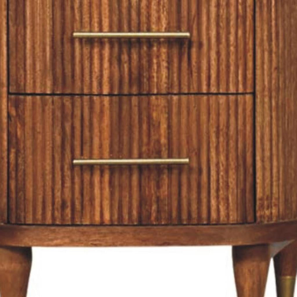 Close-up of amber wood nightstand drawer front with two gold-tone bar pulls