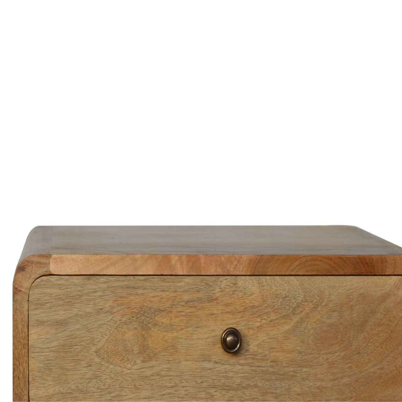 Oak nightstand top corner with round metal knob on the drawer front
