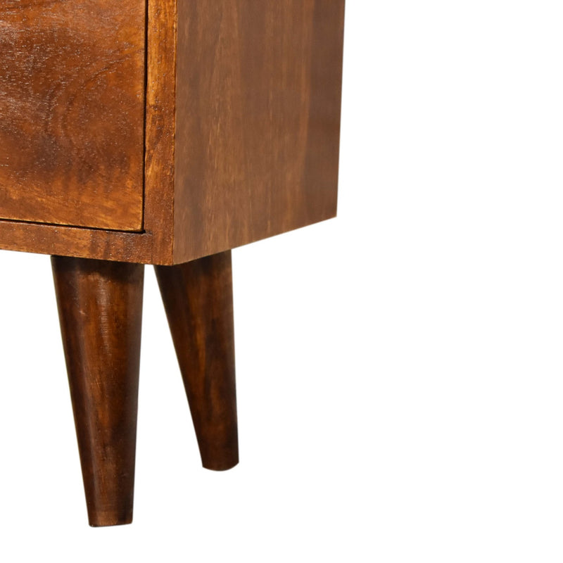 Chestnut solid wood nightstand with tapered legs and drawer fronts, close-up