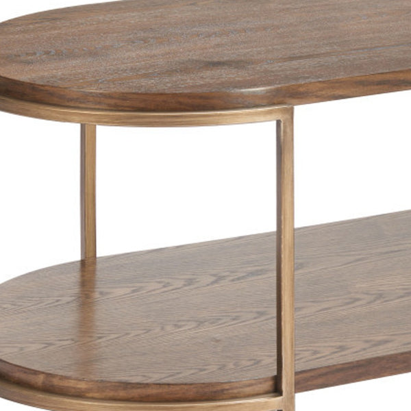Oval coffee table with warm brown wood top and lower shelf, slim steel legs.
