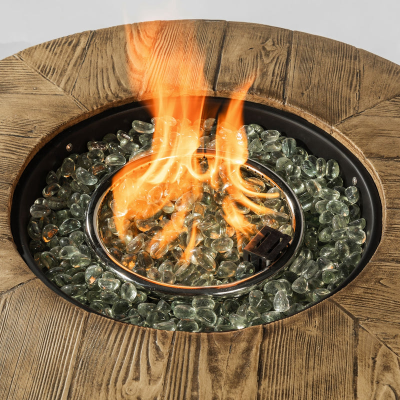 Propane fire pit burner with visible flames above clear glass lava rocks