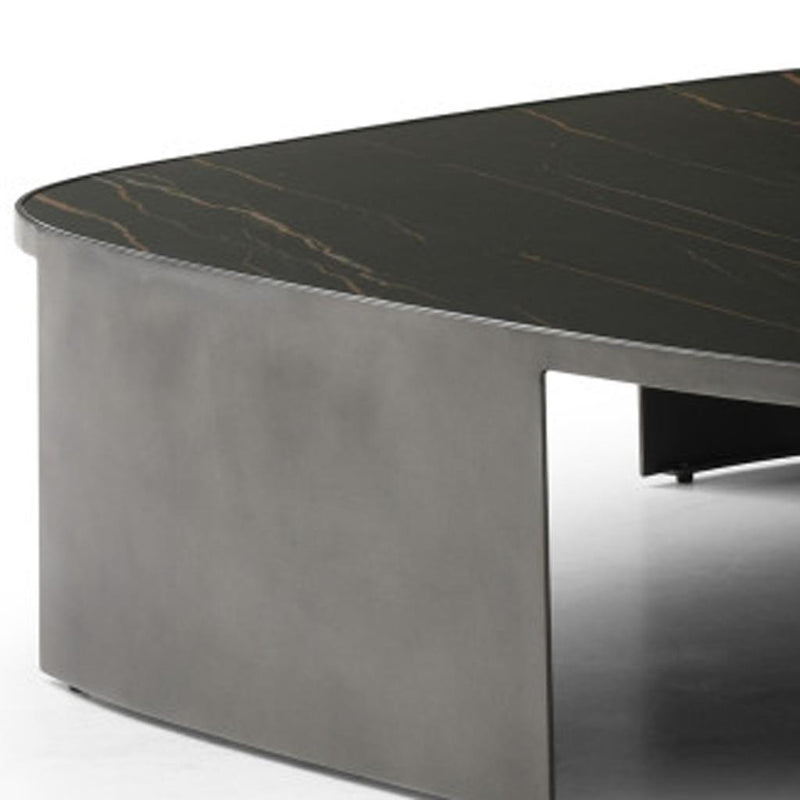 Close-up of dark ceramic tile coffee table corner with orange-gold veining and steel apron