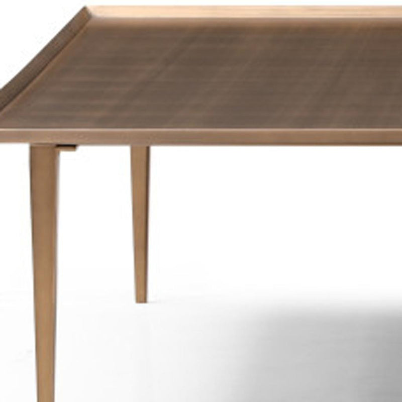 Bronze square coffee table with distressed tabletop and tapered legs.