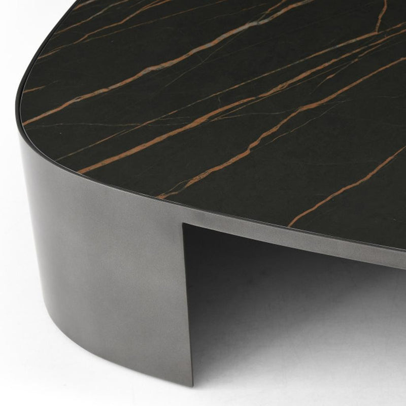 Black ceramic coffee table edge with gold veining and dark gray metal apron
