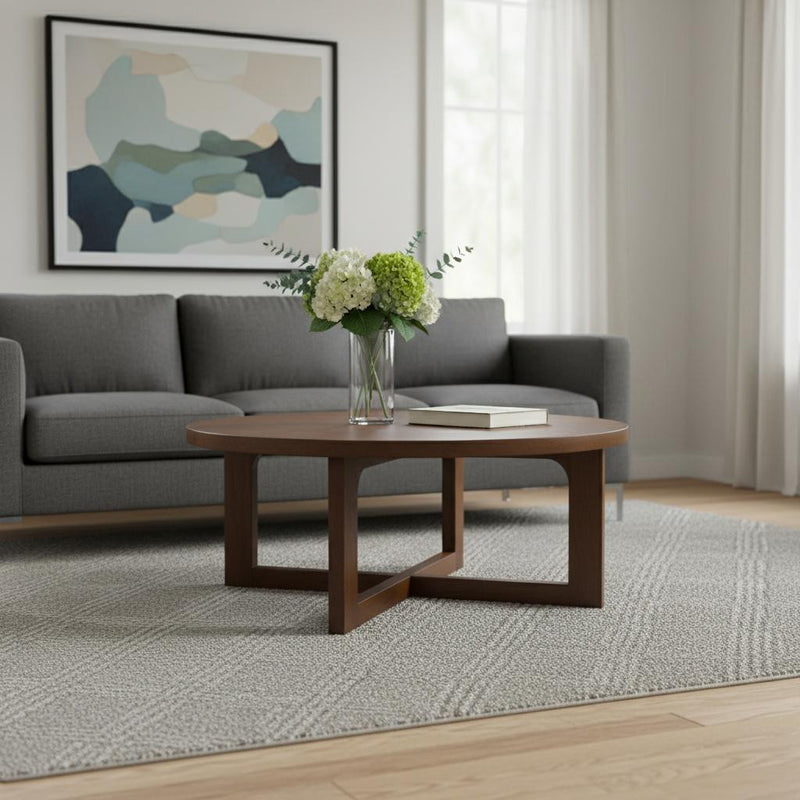 Brown round coffee table with solid wood top and X cross-leg base