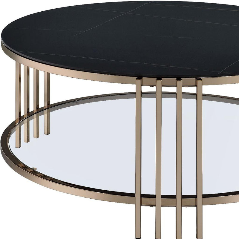 Round coffee table side view: black top with champagne legs and metal ring base.
