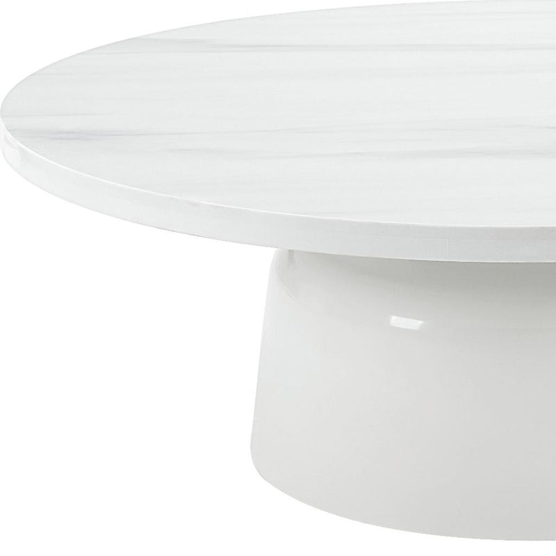 White round pedestal coffee table, close-up of marble-look top and curved base