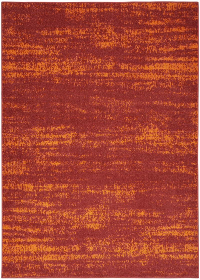 Rectangular abstract area rug in red and orange with distressed texture