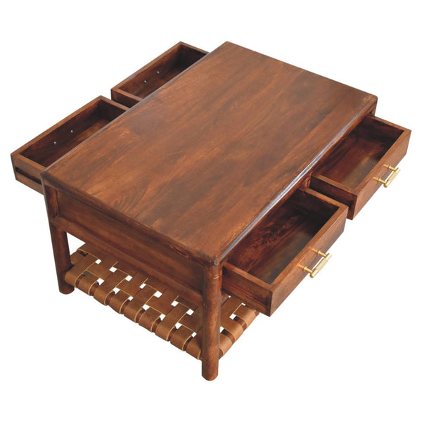 Brown solid wood coffee table with hinged top, four drawers, and woven storage shelf