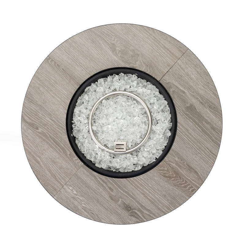 Propane column fire pit top view with clear fire glass and metal ignition ring