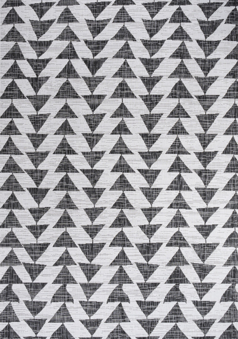 Close-up geometric pattern area rug in ivory and black, repeating triangular arrows.