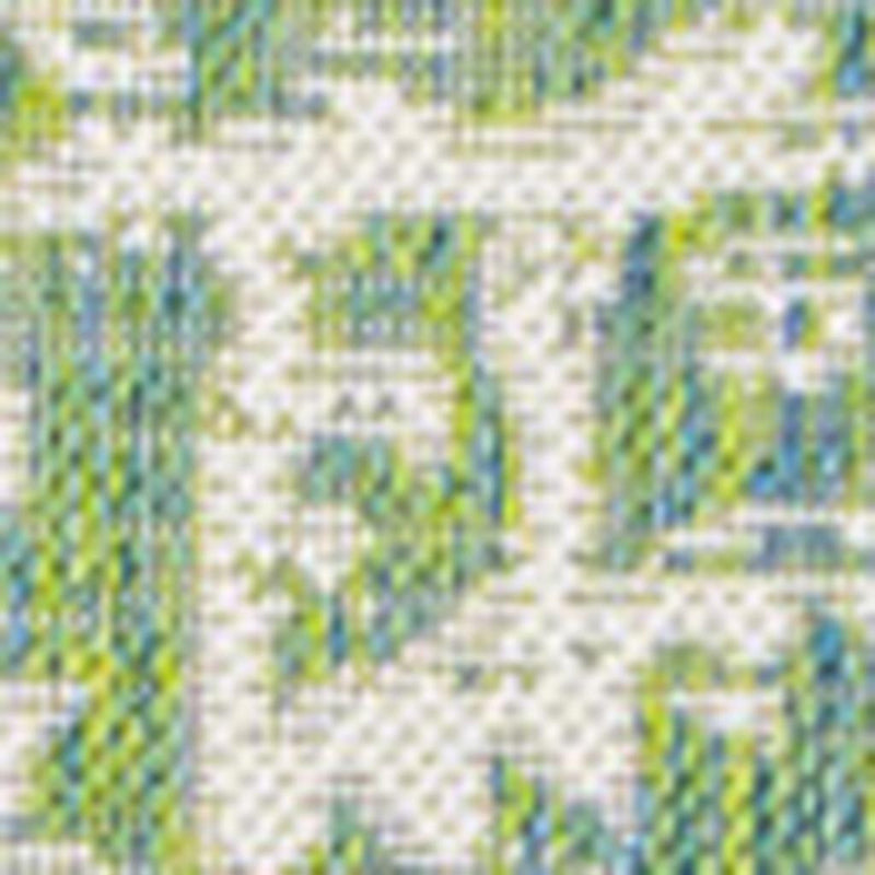 Cream and green medallion area rug detail with repeating geometric motifs and trim border.