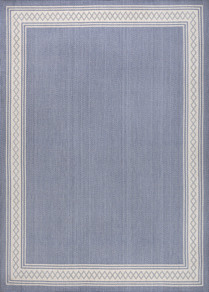 Blue area rug with cream framed border and small geometric pattern, close-up