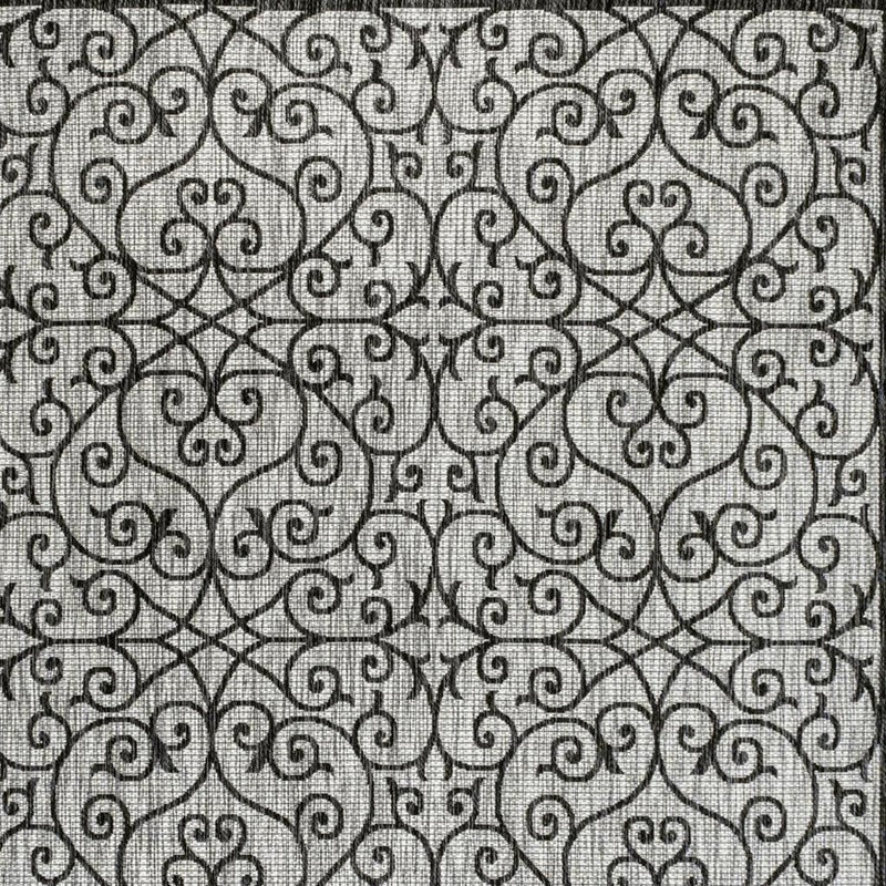Light gray geometric area rug with black scrollwork pattern