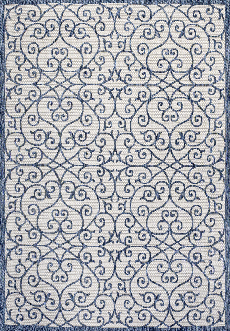 Blue and cream geometric area rug close-up with repeating scroll and star-like shapes