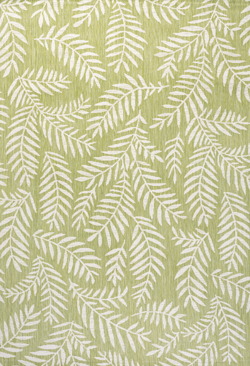 Green indoor area rug with cream fern leaf pattern, woven texture