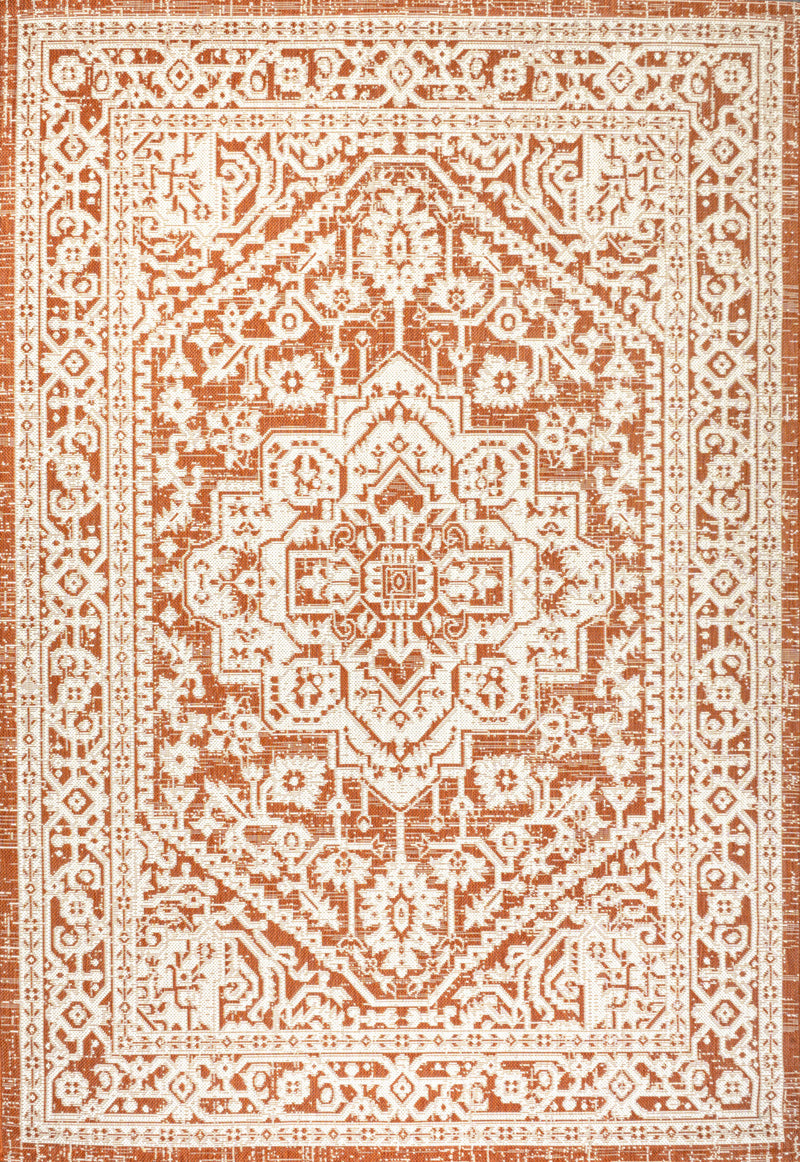 Orange and cream medallion area rug with dense geometric border and central medallion